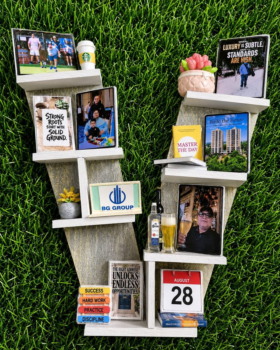 A letter-shaped Memory Wall built around a career, with company signage, photographs and a dated calendar.